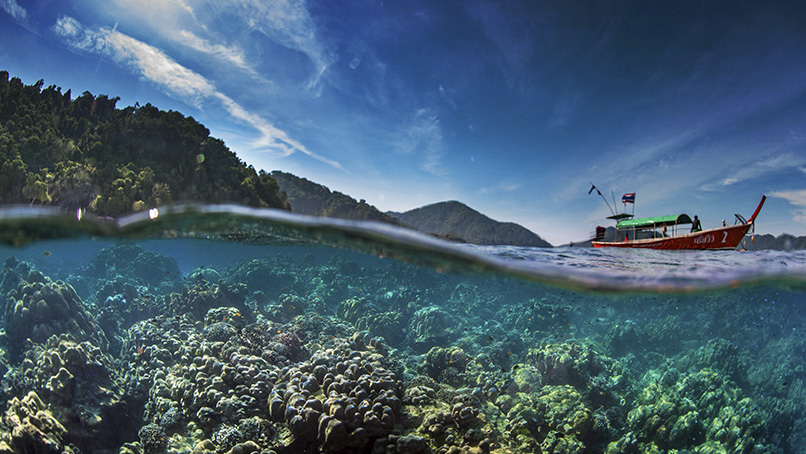 Coral reef and dive boat in a Thai marine park