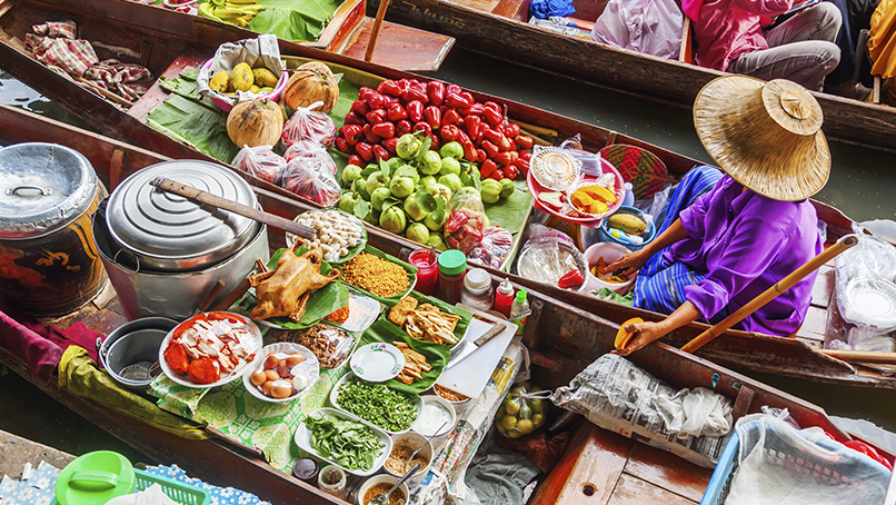 Fresh produce and cooked dishes on a market boat