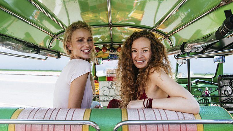 Travellers riding in a Thai tuk-tuk